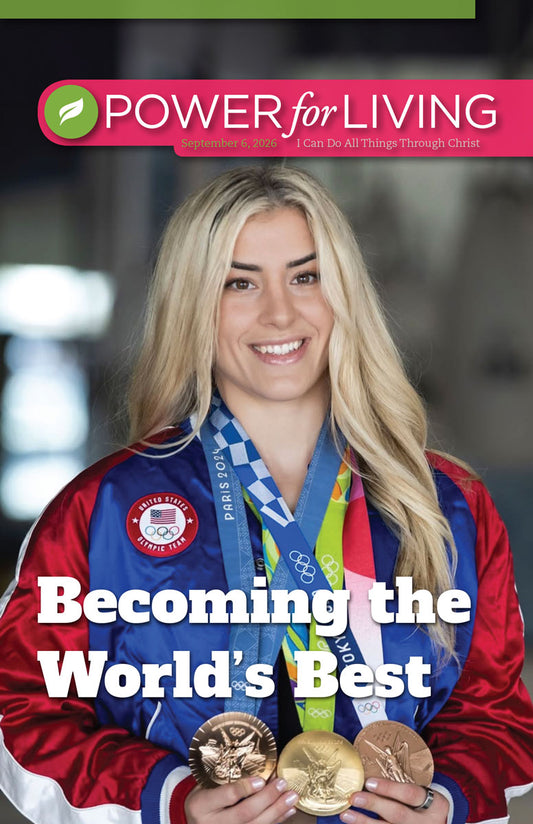 Woman holding Olympic medals with 'Power for Living' magazine cover in the background
